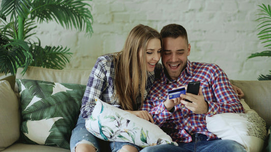 Couple shopping online on a smartphone to improve product page conversion on Shopify